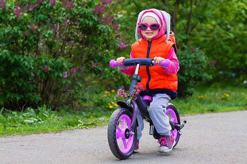 little girl learning ride a bicycle